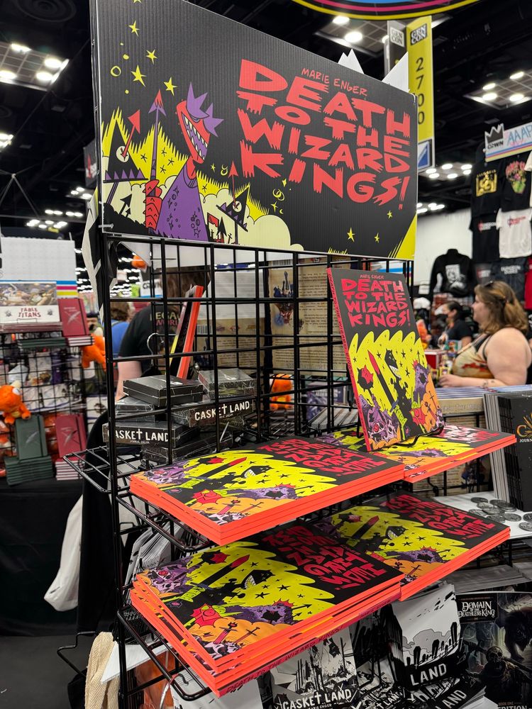 A photo of death to the wizard kings and casket land on the crwn booth 