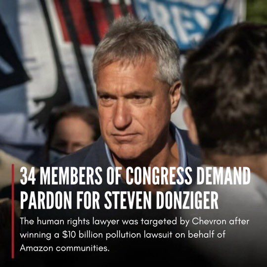 A photo of Steven Donziger at a rally, with the text, 34 MEMBERS OF CONGRESS DEMAND PARDON FOR STEVEN DONZIGER: The human rights lawyer was targeted by Chevron after winning a $10 billion pollution lawsuit on behalf of Amazon communities.