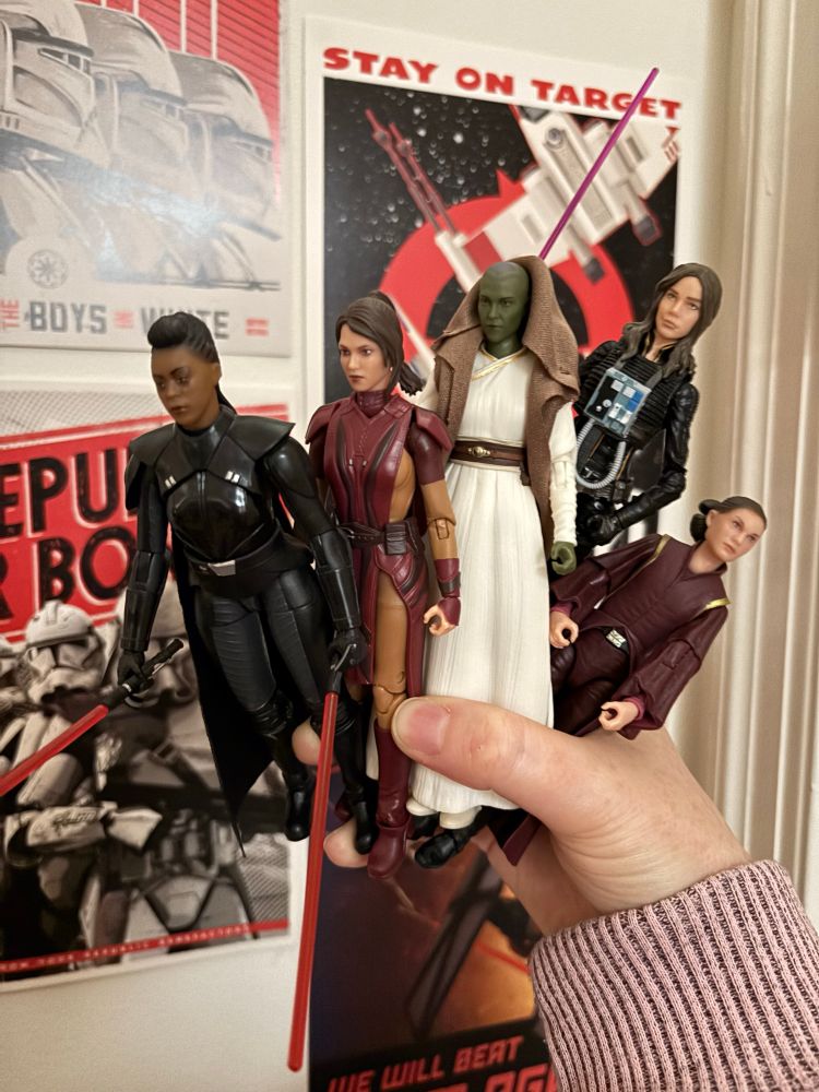 Star Wars figures - Reva, Bastila, Vernestra, Jaina, and Padme - in front of Clone Wars propaganda posters 