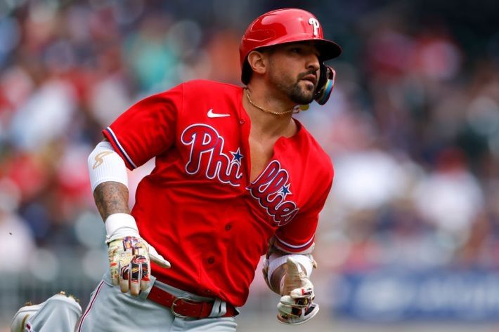 Philadelphia Phillies' Nick Castellanos has the two top buttons of his red, alternate jersey unbuttoned as he runs the bases.