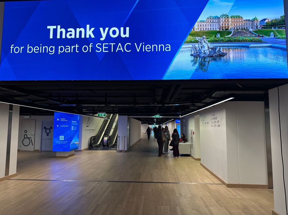 Banner of SETAC 2025 saying “Thank you for being part of SETAC Vienna” on top of a long corridor