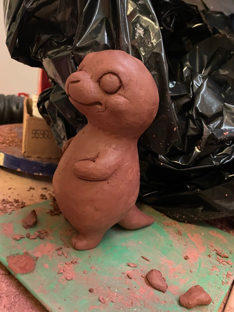 A cute otter made fram brown clay.