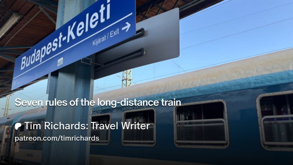 Blue sleeper train waiting at a Budapest platform.