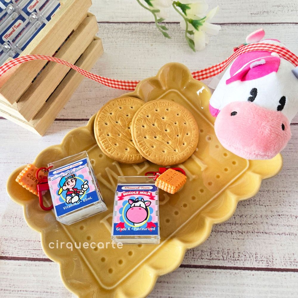 A photo of my Harvest Moon themed milk carton charms! The design features the player character on one side and a cow on the other side.

Text on the charms: "Mineral Town: WHOLE MILK
Grade A - Pasteurized"

"Mineral Town: Always Fresh and Delicious!
Vitamin D - 65mL"