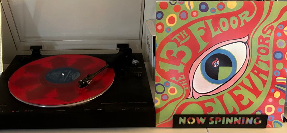 Outer sleeve and spinning red vinyl record. The 13th Floor Elevators “The Psychedelic Sounds of the 13th Floor Elevators”
