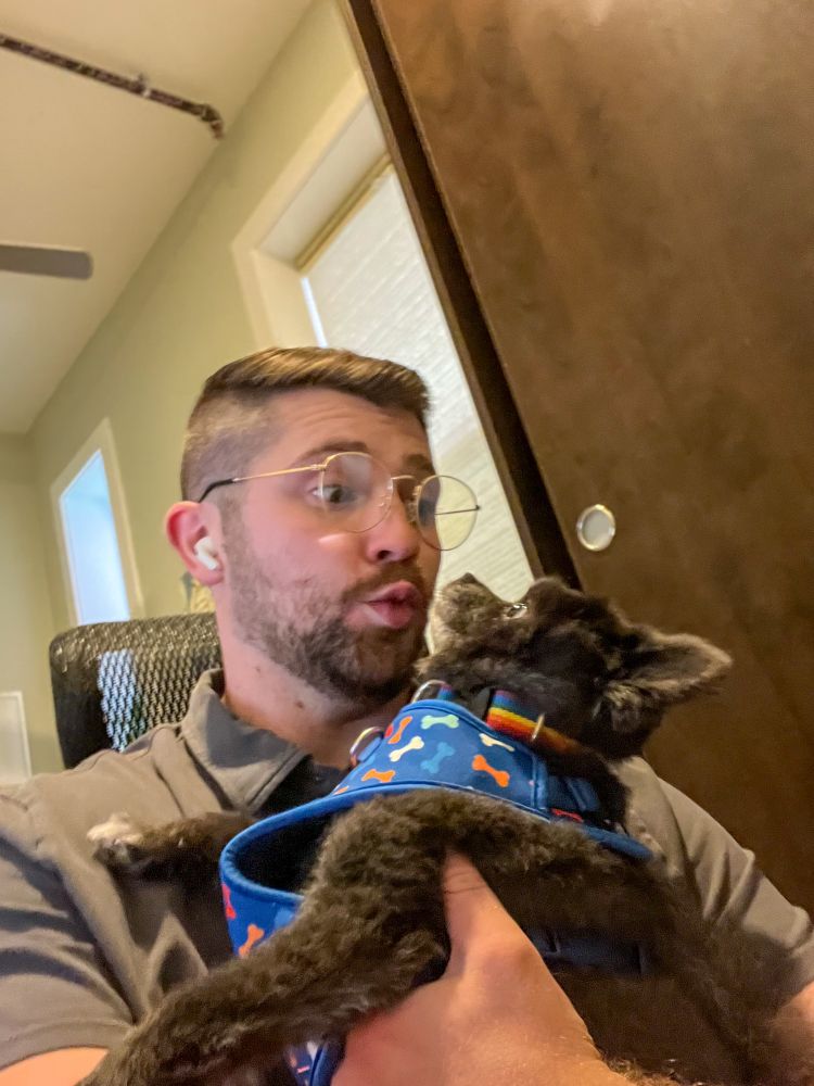 man with a black pomeranian 