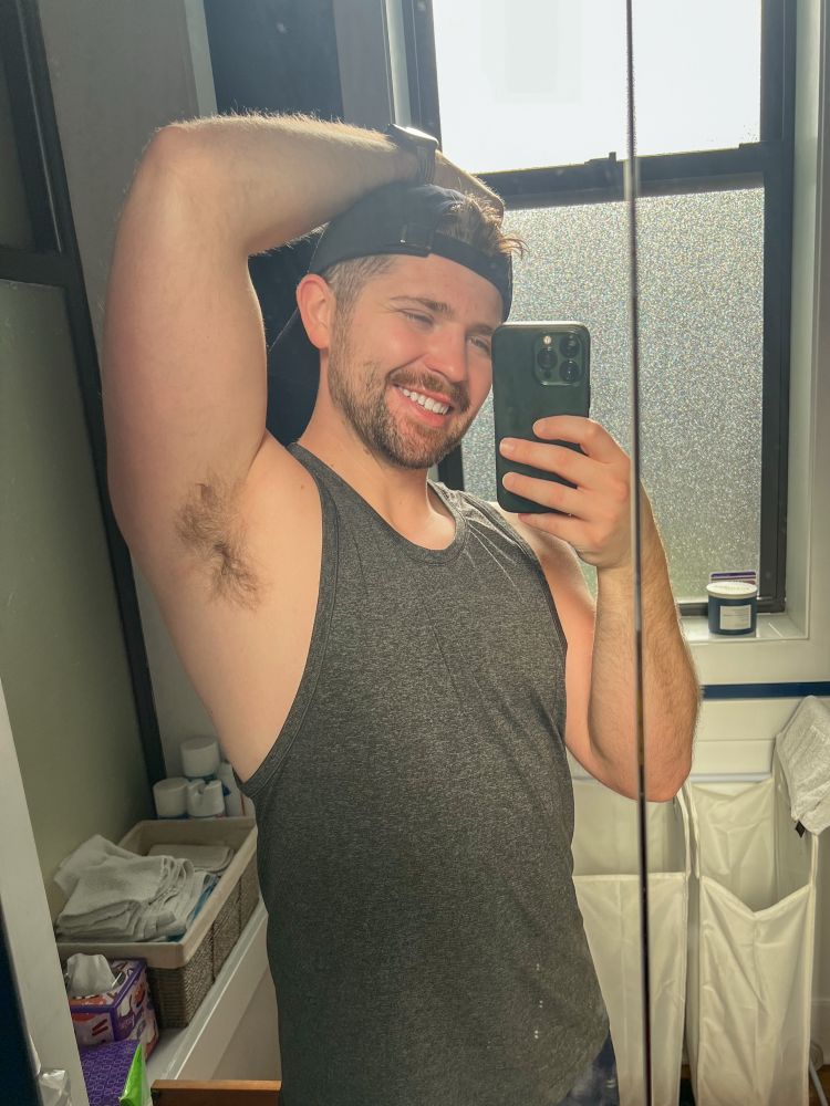 man with a beard in a gray tank