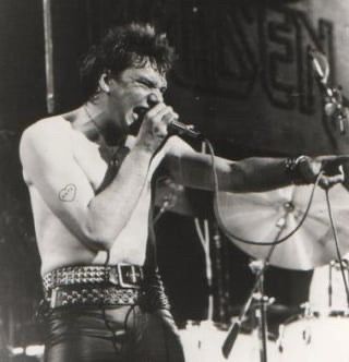 Paul Di’anno, shirtless and sweaty, singing for Iron Maiden at an early gig