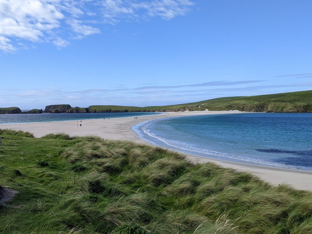 The Tombolo beach between Mainland and St Ninian's Isle, Shetland. The waves break in on either side. A beautiful sunny day.