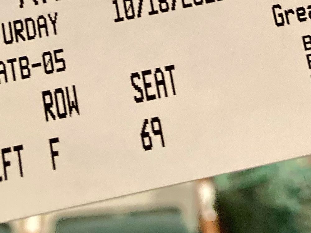 An event ticket for a seat in Row F, Seat 69.