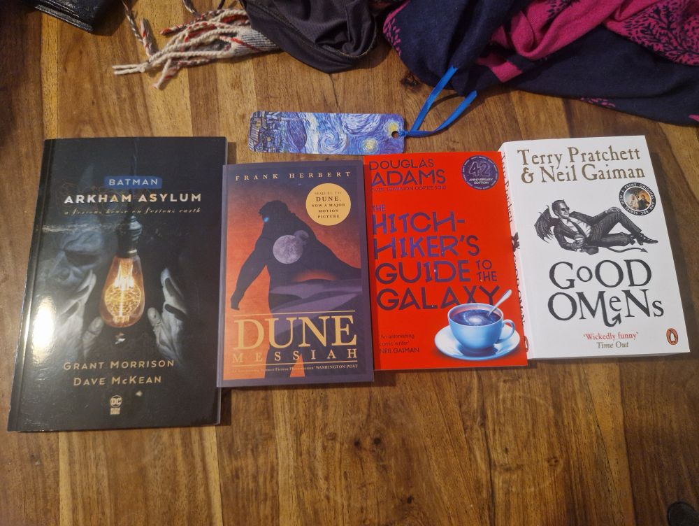 from left to right: 
- Batman Arkham Asylum A Serious House on Serious Earth by Grant Morrison
- Dune: Messiah by Frank Herbert
- The Hitchhiker's Guide to The Galaxy by Douglas Adams
- Good Omens by Terry Pratchett and... someone else.