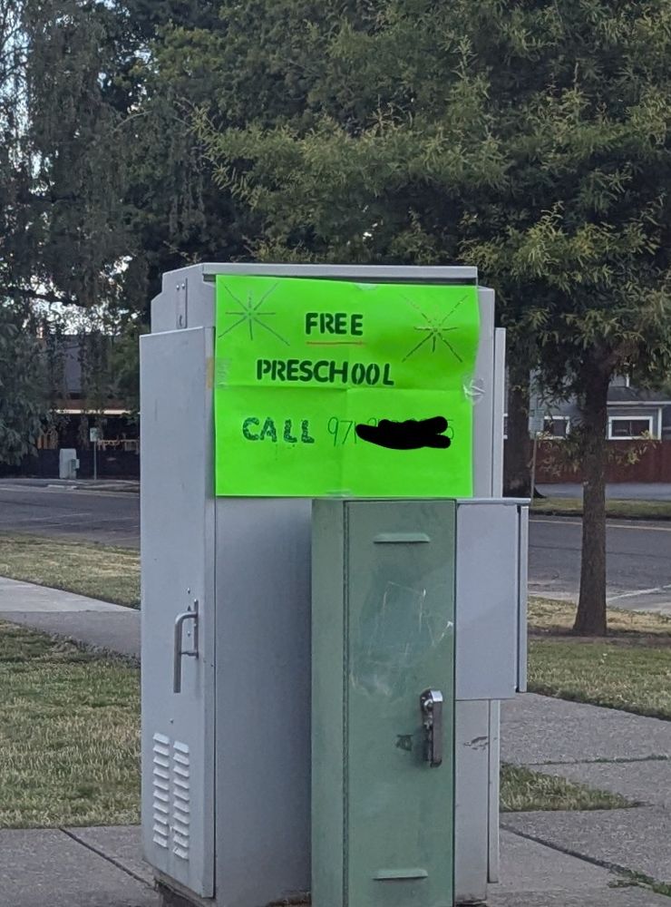 a crudely made poster reading "free preschool" with a phone number.  no other info whatsoever.