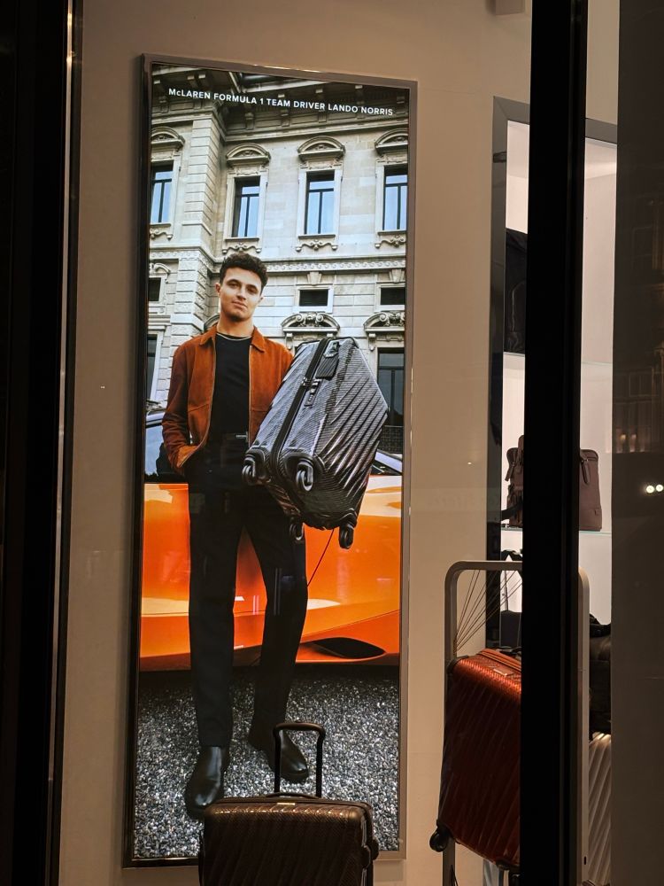 Poster of Lando Norris holding a suitcase