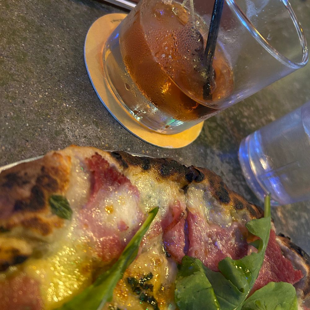 Pizza.
It’s got smoked ham, Gruyère, sage, arugula. No tomato sauce. Plus a cocktail.
