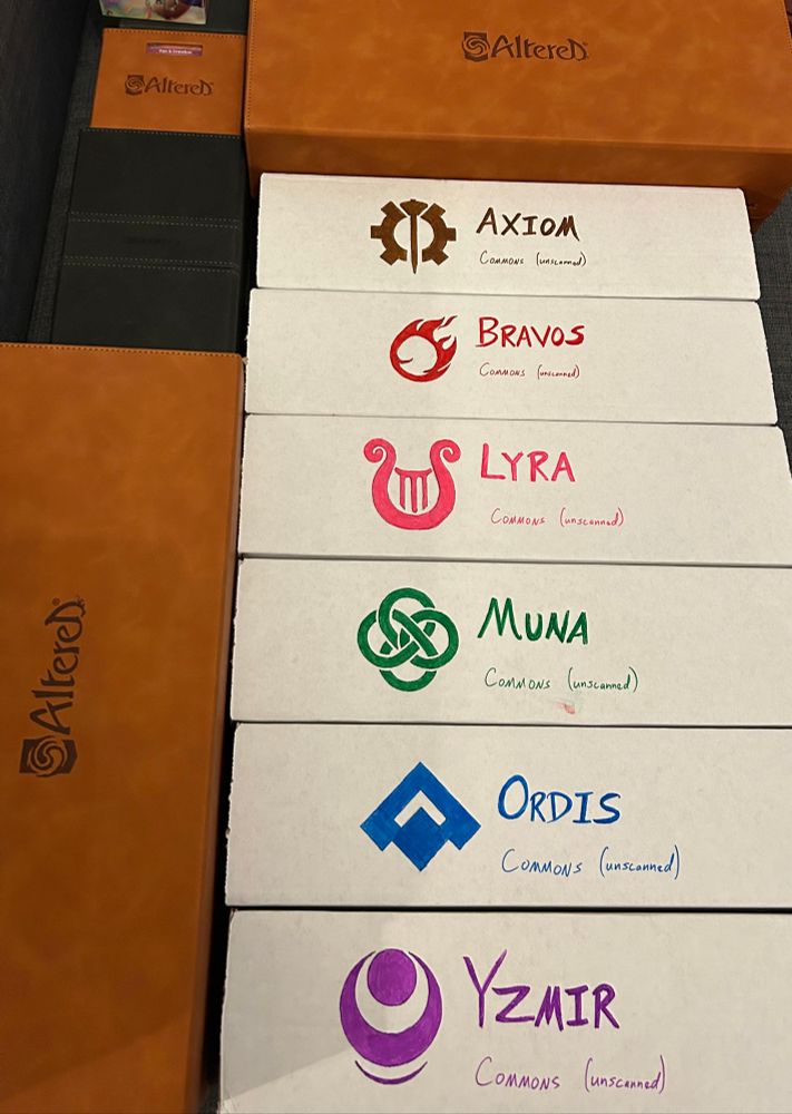 A large collection of cards in boxes, from the Altered TCG.