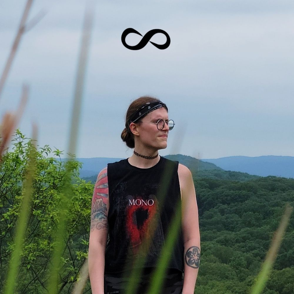 The cover art for Healing, featuring sheisinfinite gazing into the distance in front of a mountain range. The sheisinfinite logo sits of top of the photo.