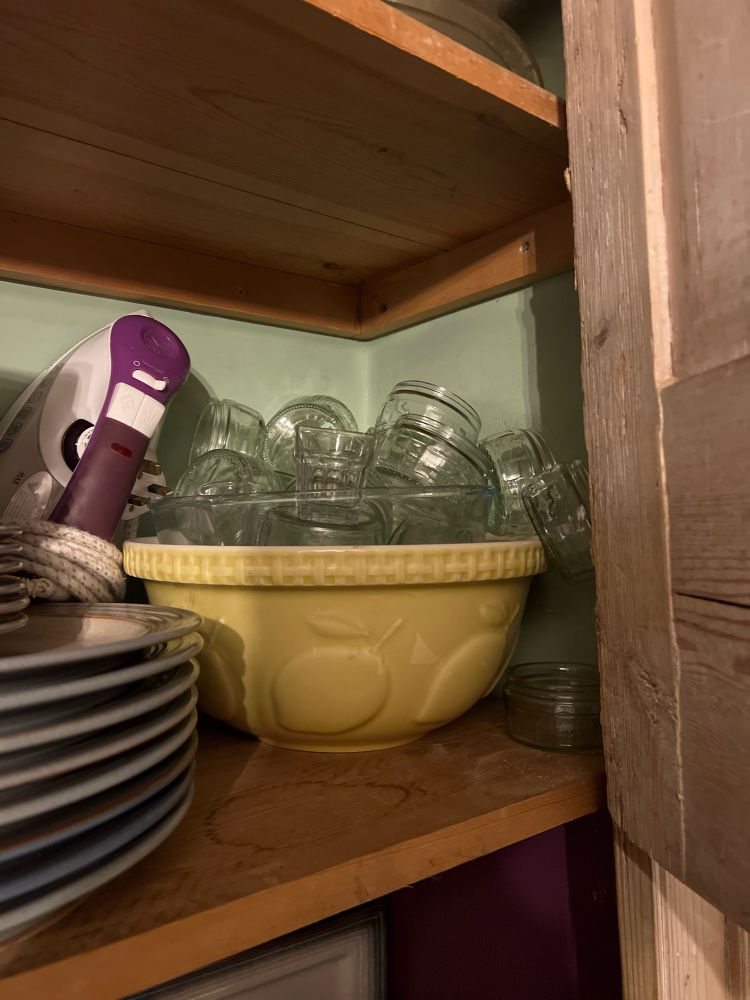 An old fashioned mixing bowl in yellow with apple shapes embossed.