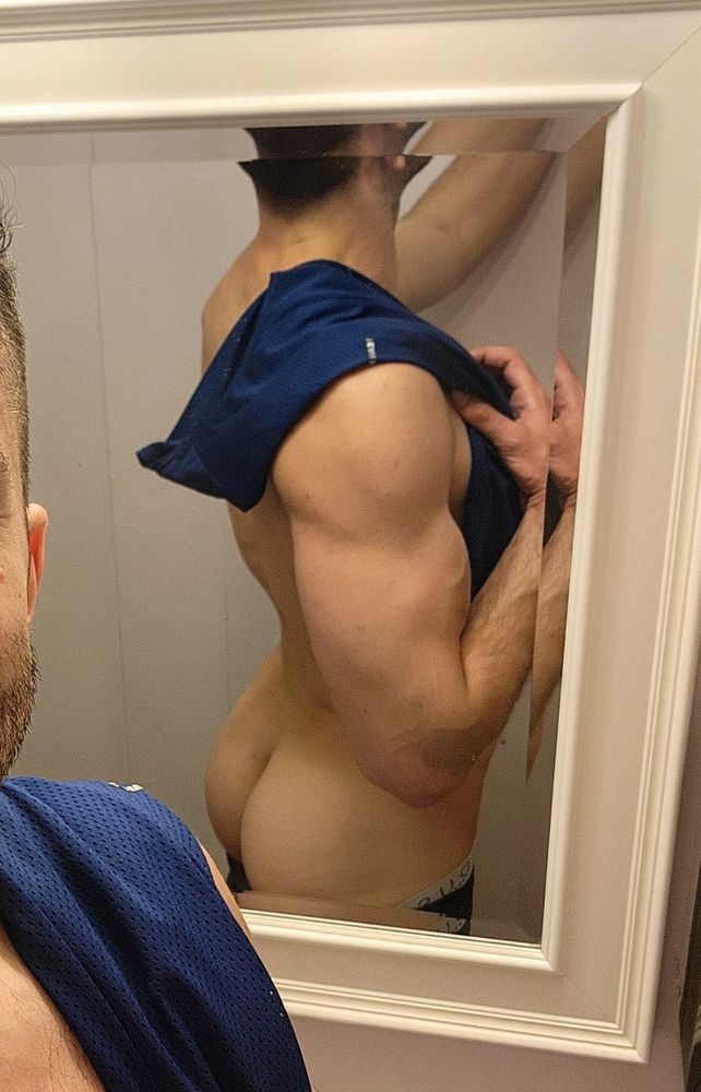 Backside gym bathroom pic with tank top tossed over shoulder 