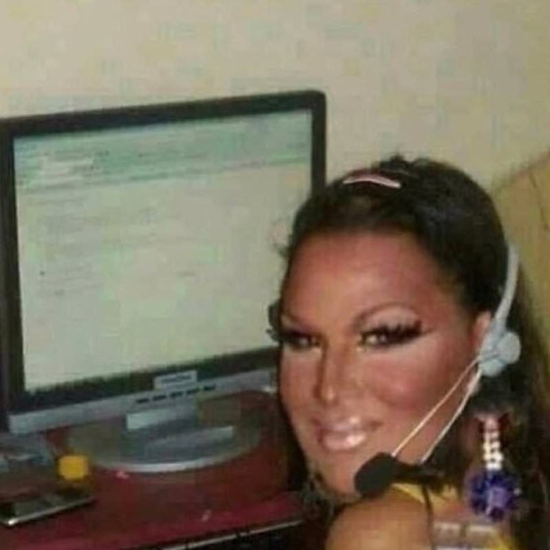 Roxxxy Andrews sitting at computer with headphone microphone on