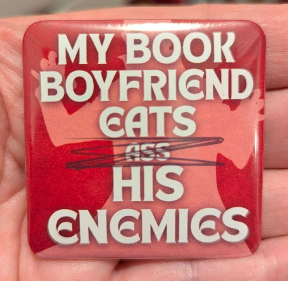 Big red square badge with the silhouette of a vampire in the background. Text reads "My Book Boyfriend Eats [Ass is crossed out] His Enemies". 