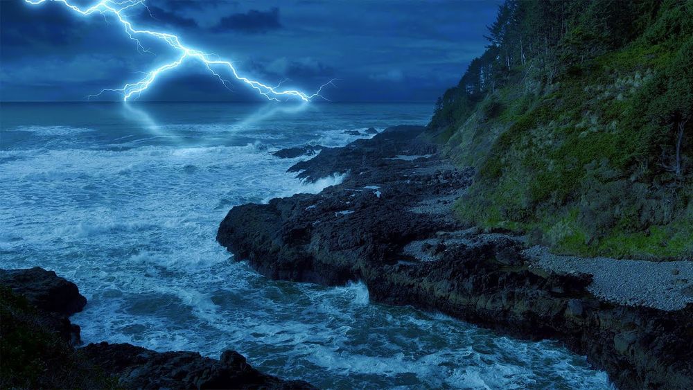 Lightning strikes ocean, seen from coast.