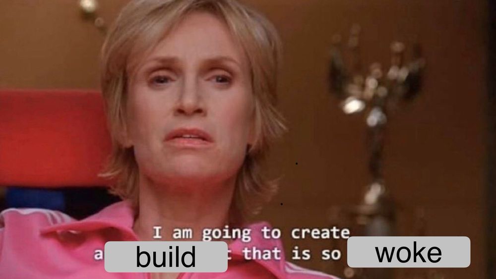 Image of a Glee character, portrayed by Jane Lynch, wearing a pink tracksuit, sitting in an armchair with a stern expression. Text overlay reads: ‘I am going to create a build that is so woke.’