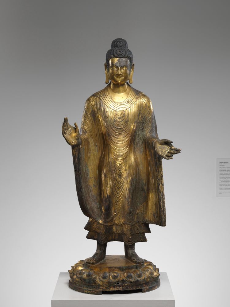 Buddha Maitreya (Mile)
China
dated 486 (10th year of Taihe reign)
On view at The Met Fifth Avenue in Gallery 208
This is the largest early gilt-bronze Chinese sculpture known today. The Buddha’s broad shoulders, powerful physique, and long legs derive from fifth century Indian prototypes that spread to China along the Silk Road, an example of which can be seen directly behind you in the gallery for Indian art.

Maitreya is worshiped both as a bodhisattva and as a Buddha, for it is believed that once the current cosmic era has destroyed itself, he will be reborn as the teaching Buddha of the next great era. The identification of this figure as the Buddha Maitreya is based on the dedicatory inscription at the back of the base, which dates the sculpture to 486 and states that it was commissioned in honor of the dowager empress Wenming (442–490), who controlled the Northern Wei dynasty during the last three decades of the fifth century.

Period: Northern Wei dynasty (386–534)
Date: dated 486 (10th year of Taihe reign)
Culture: China
Medium: Gilt bronze with traces of pigment; piece-mold cast
Dimensions: H. 55 1/4 in. (140.3 cm); W. 24 1/2 in. (62.2 cm); D. 19 1/4 in. (48.9 cm)
Classification: Sculpture
Credit Line: John Stewart Kennedy Fund, 1926
Object Number: 26.123

Via the Met