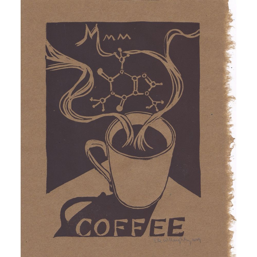 My linocut print in deep brown on lighter brown washi paper with a deckle edge on the right side shows a mug of coffee with a shadow on the corner of a table and wave aroma lines with a caffeine molecule and the word “Mmm” with “COFFEE” in the shadow below.
