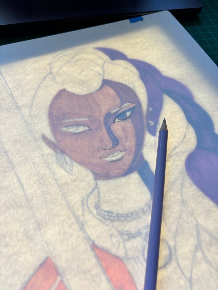 Partially colored piece of Rumi on a light pad. 