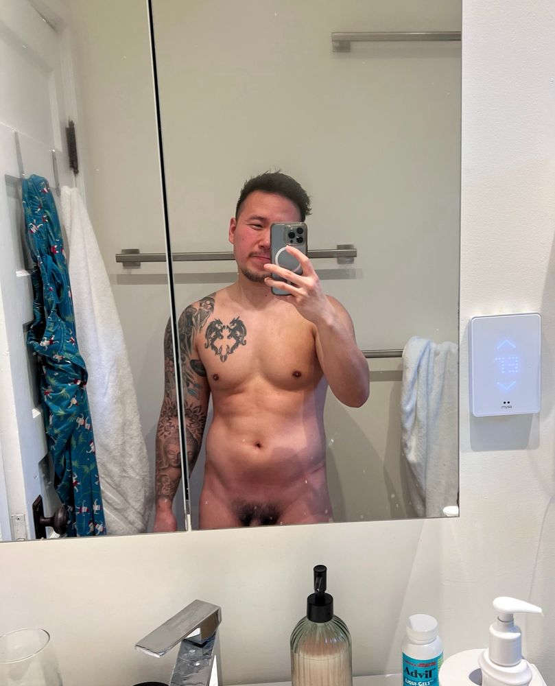 Naked mirror selfie of man showing pubes and base of penis 