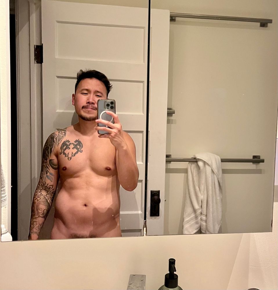 Naked mirror selfie of a man showing hint of pubes