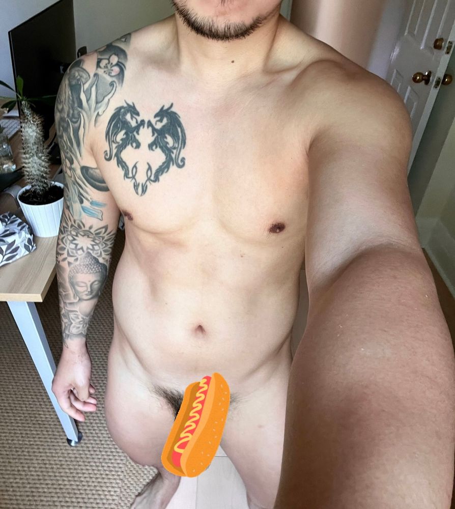 Naked torso and lower body of a man with a hot dog sticker covering crotch