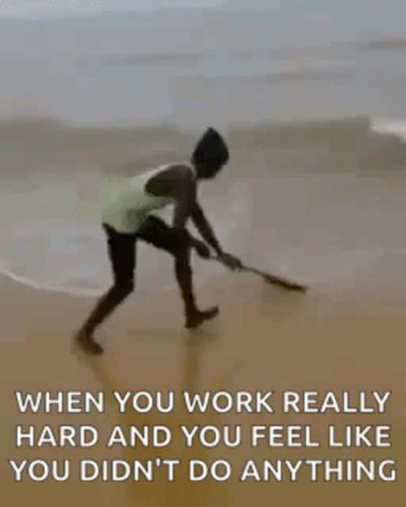 a man is walking on a beach with a fishing rod in his hand .