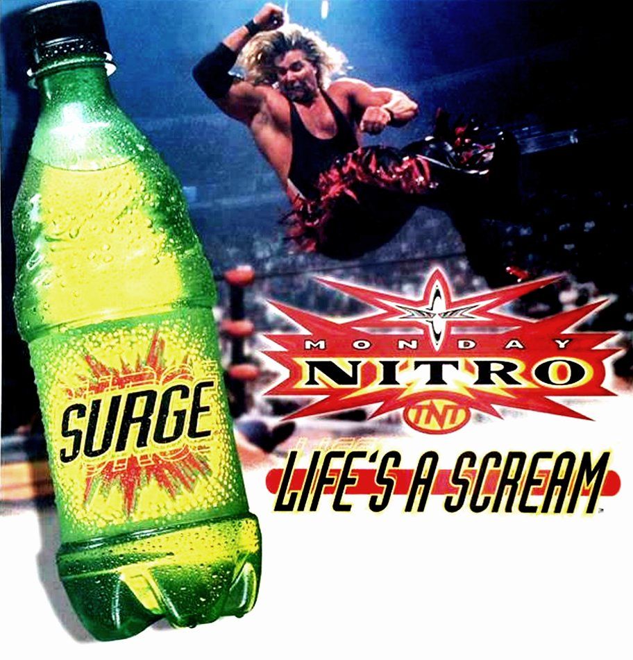An ad for Surge soda that's also a tie-in for WCW Nitro. The ad shows Kevin Nash mid-air about to hit an elbow drop... seemingly on a big bottle of Surge. The Nitro logo is below Nash, and Surge's slogan ("Life's a Scream") is below the logo.