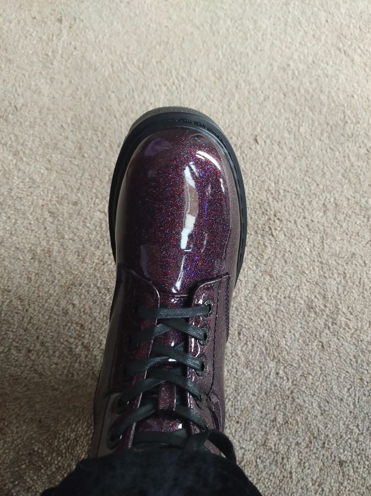 A purple, glittery patent Doc Martens style boot