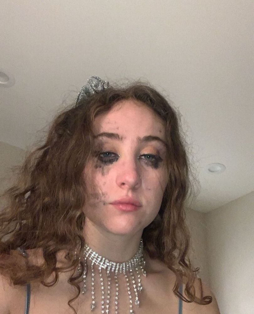 Chappell Roan with smeared eyeliner on her face looking like she’s cried for hours 