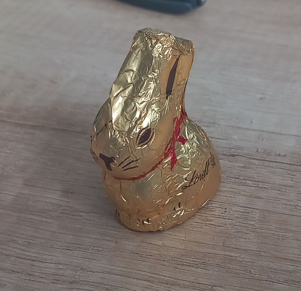 Chocolate rabbit with the paper on