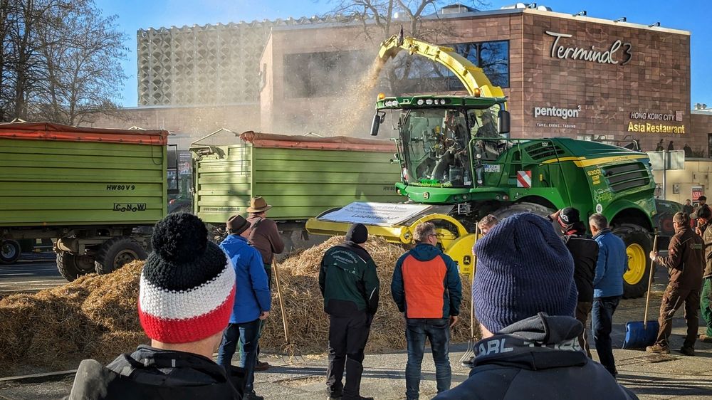 Bauer beobachten eine Protestaktion in Chemnitz.
Einer trägt eine Mütze in den Farben Schwarz-Weiß-Rot.