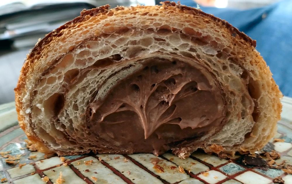 A chocolate orange croissant, cleaved expertly in half to reveal its airy lamination and chocolate orange creme interior. Yes, Reader, we shared it.