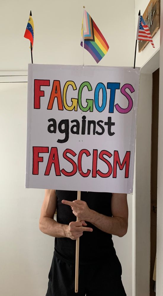 Ready for World Pride and the DC Pride Rally and March!!! 🏳️‍🌈🏳️‍⚧️

A protest sign that reads “FAGGOTS against FASCISM” with three flags poking out the of top, a Venezuelan flag, Progressive Pride flag, and USA flag, being held by two gay hands that are flipping off the camera gay