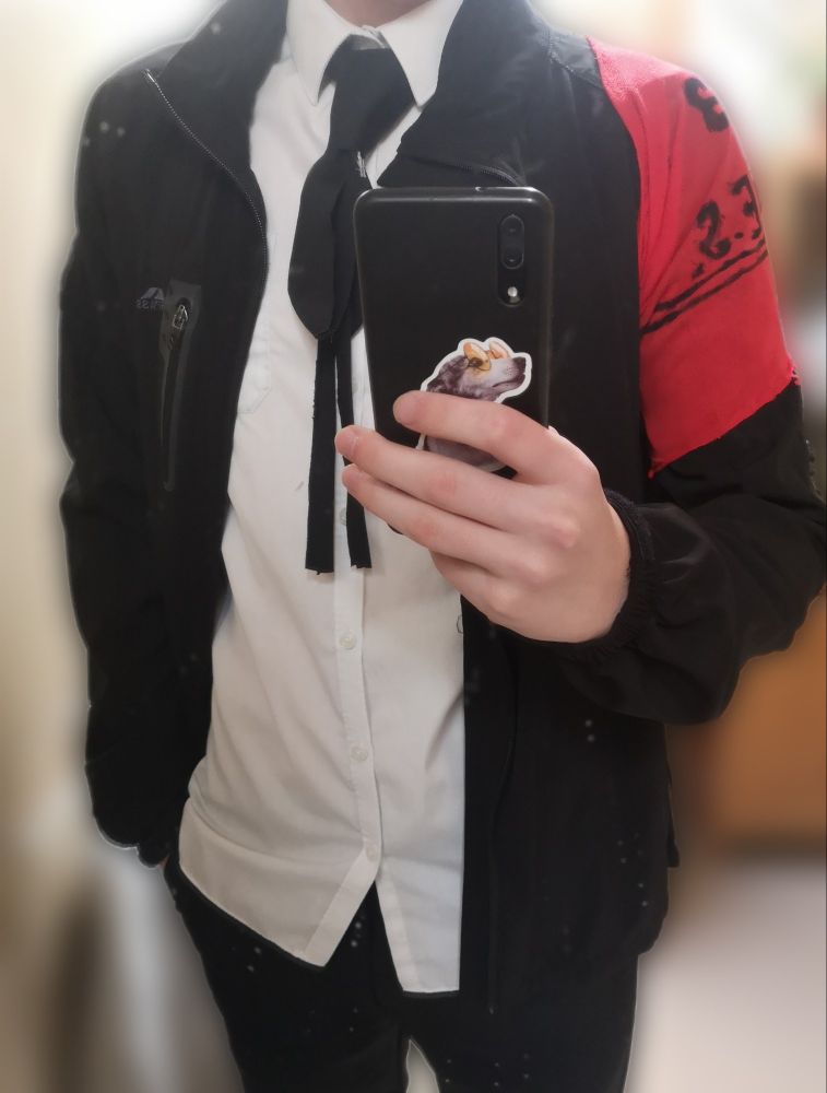 A makoto yuki outfit with a red shoulder on a black jacket and a fancy looking tie thingy