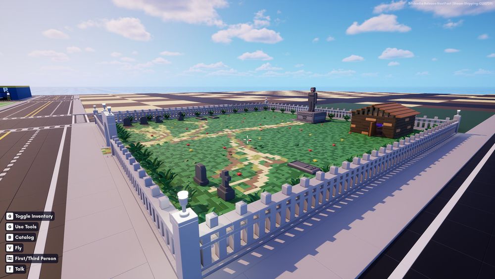 a grassy graveyard make of bricks, it has a small house in it and a stone statue in the back middle