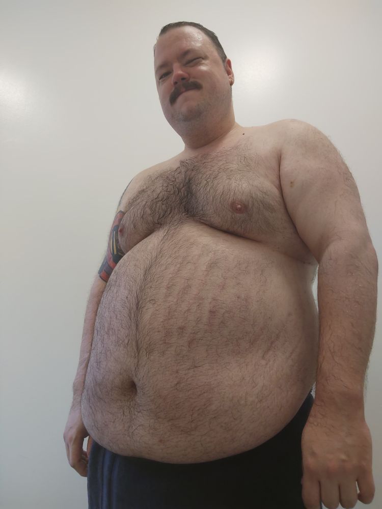 A three-quarters view of a chubby man in a towel