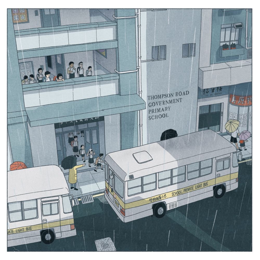 A digital illustration depicts a rainy day on a Hong Kong street. Two light yellow school buses with the text "SCHOOL PRIVATE LIGHT BUS" and Chinese text are prominently featured. Rain is depicted with diagonal white lines, and a gray wash suggests a wet street. In the mid-ground, a two-story light gray building with a dark gray sign reading "THOMPSON ROAD GOVERNMENT PRIMARY SCHOOL" is visible. Small figures representing children wearing light blue and white uniforms are gathered under a dark gray awning at the school entrance. More children in the same uniforms are visible on the second floor. On the right side of the image, a portion of a building with a sign in Chinese characters is visible. The overall tone is muted and gray, reflecting the rainy atmosphere.