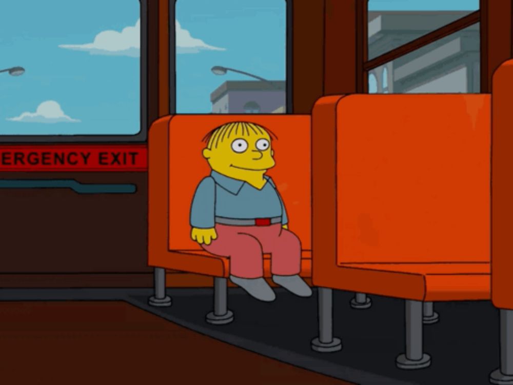 a cartoon character sits on a bus with an emergency exit sign behind him