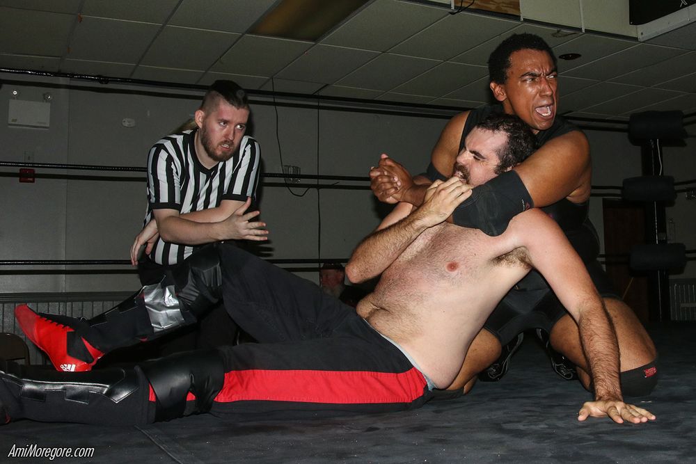 Hawkins with a chin lock on Radex