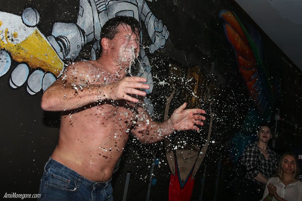 Tony Deppen getting splashed with beer in his face