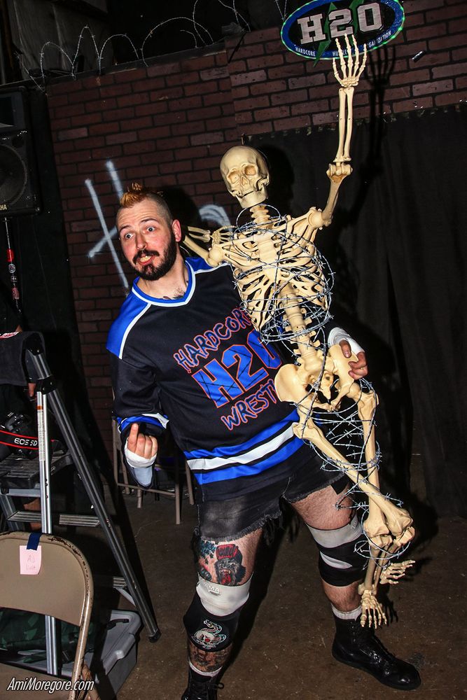 JB Anderson makes his entrance while carrying Kyle, a barbed wire wrapped skeleton