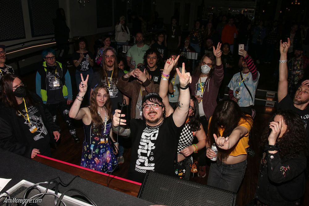 Graz and the crowd waving at the camera while Graz performs