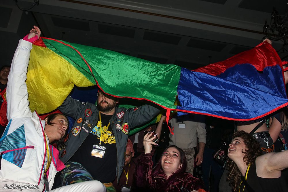 attendees playing with a rainbow parachute during the Ultradeluxe show